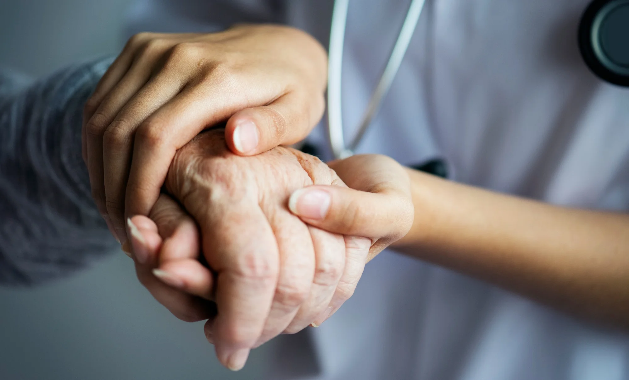 caregivers holding hand